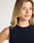 Close up of black material on collar and shoulder of blonde woman