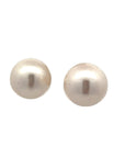 A pair of round pearl stud earrings against a white background.