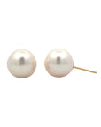 A pair of round pearl stud earrings against a white background.
