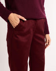 Close up of maroon sweater and pants set on a white background