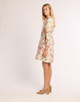 Woman wearing a floral dress on a plain background