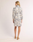 Woman wearing a floral dress on a plain background