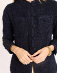 Navy blue textured jacket worn by a woman on a white background