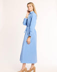 Woman wearing a light blue dress on a white background