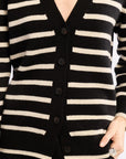 Black and white striped cardigan with buttons on a plain background