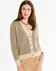 A woman modeling the Camel Tri-Color Check Classic Cashmere Cardigan with camel trousers, front view, photographed against a plain white studio background.