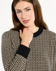 Close-up of the black crew neckline, cuff, and check pattern of the Black Tri-Color Check Classic Cashmere Crew, photographed against a plain white studio background.