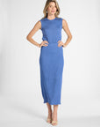 Woman modeling a pleated blue skirt and shell on a white backdrop