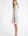 Woman wearing a patterned dress on a white background