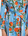 Dress with oranges and striped pattern on a plain background