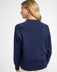 Woman wearing a navy blue sweater on a white background