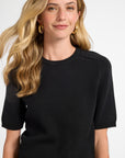 Woman wearing a black t-shirt against a white background