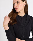 Woman modeling a black tissue cardigan on a white background