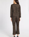 A woman shown from the back wearing a matching dark brown tweed blazer and cropped trousers set with a small gold geometric pattern, paired with black high heels, against a light gray studio background.