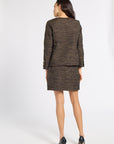 A woman is shown from the back wearing a matching tweed blazer and mini skirt set in a brown and gold pattern, paired with black high heels, against a plain white studio background.