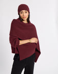 Woman wearing a burgundy cashmere scarf in a studio