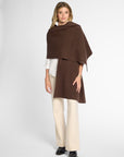 Another Front View: Woman wearing a chocolate brown wrap on top of a white button up shirt and khakis in front of a white background.