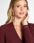 close up view of woman in Wine button-up cardigan in front of neutral background.