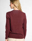 back view of woman in Wine button-up cardigan in front of neutral background.