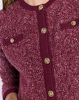 Close up of button detailing on a purple sweater