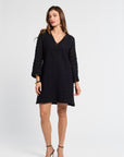 Woman wearing a mini black dress on a white background