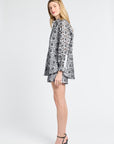 Woman wearing a black floral long sleeve blouse on a white background