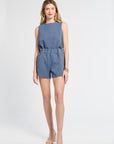 Woman wearing a pair of blue floral shorts on a white background
