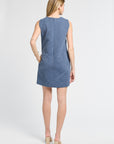 Woman wearing a blue floral sleeveless dress on a white background