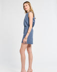 Woman modeling a pair of blue floral shorts on a white background