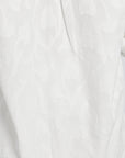 Close-up image of a white floral pattern on an article of clothing