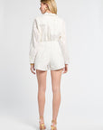 Woman with blonde hair modeling floral white shorts on a white background