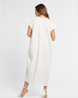 Woman wearing a long white dress on a white background