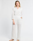 Woman wearing white lace pants on a white background