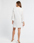 Woman wearing a white lace dress and heels on a white background