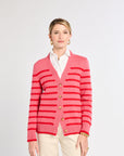 Woman wearing a pink striped cardigan on a white background