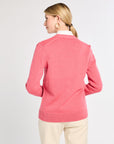 Woman wearing a pink sweater on a white background