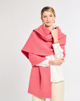 Woman wearing a pink scarf on a white background