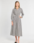Woman wearing a gray and white striped dress on a white background