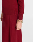 Red outfit with a gold bracelet on a white background