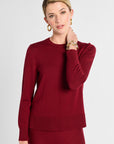 Woman wearing a red sweater on a white background
