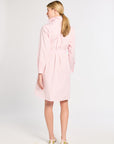 Woman wearing a light pink dress on a white background