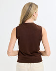 Woman wearing a brown sleeveless top against a white background
