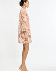 Woman wearing a patterned dress on a white background