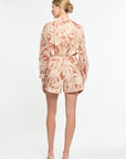 Woman wearing a patterned dress on a white background