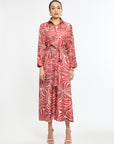 Woman wearing a red and white patterned dress on a white background