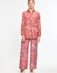 Woman wearing a red and white patterned outfit on a white background