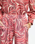 Red and white patterned shirt and pants set on a plain background