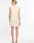 Woman wearing a beige dress on a white background
