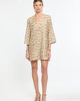 Woman wearing a beige floral dress on a white background