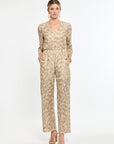 Woman wearing a patterned jumpsuit on a white background